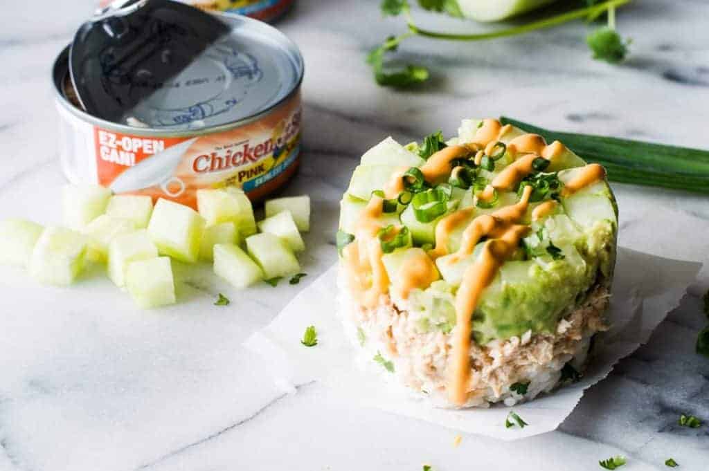 Salmon Stacks!! This super simple recipe is the perfect light and fresh snack, lunch, or light dinner! Sure to impress!!! This dish has layers of fluffy cilantro, lime rice. Salmon mixed with a spicy mayo. Smooth and creamy avocado. And fresh and cool cucumber. Forget getting that pricey sushi! Make this scrumptious snack at home!