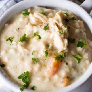 Slow Cooker Creamy Chicken and Wild Rice Soup! This soup is ultra creamy, ultra flavorful, and best part? There's no actual cream or butter used! This is the perfect lighter version of a classic comfort food.