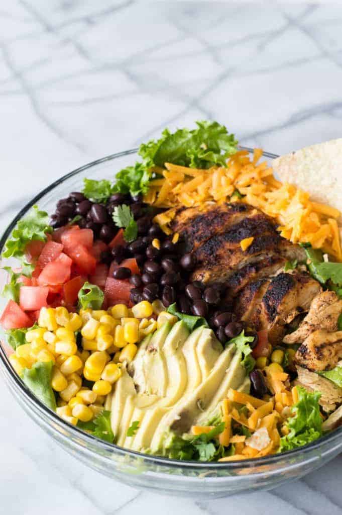 Chicken Taco Salad with juicy chicken bursting with flavor thanks to homemade taco seasoning. All topped with an intoxicating cilantro ranch dressing.