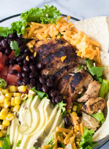 Chicken Taco Salad with juicy chicken bursting with flavor thanks to homemade taco seasoning. All topped with an intoxicating cilantro ranch dressing.