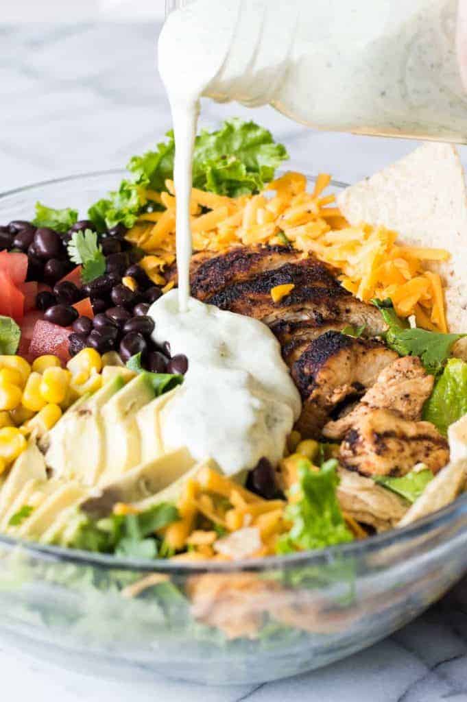 Chicken Taco Salad with juicy chicken bursting with flavor thanks to homemade taco seasoning. All topped with an intoxicating cilantro ranch dressing.