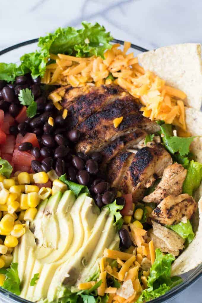 Chicken Taco Salad with juicy chicken bursting with flavor thanks to homemade taco seasoning. All topped with an intoxicating cilantro ranch dressing.