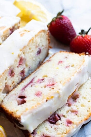 Homemade yogurt pound cake made with strawberries and lemon with a lemon zest glaze on top.