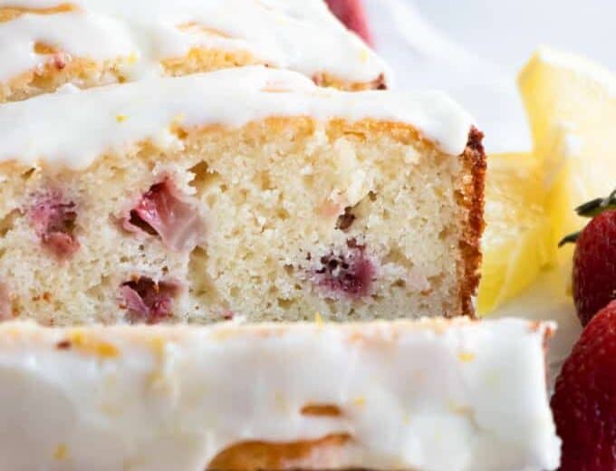 Sliced strawberry lemon pound cake with a lemon glaze.