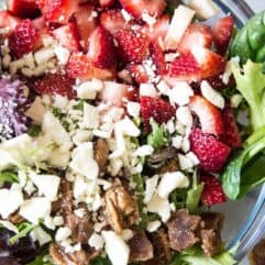 Strawberry Salad with Poppyseed Dressing. This salad is loaded up with fresh strawberries, candied pecans, feta cheese and drizzled with an easy to make sweet poppyseed dressing. Perfect dish for springtime!
