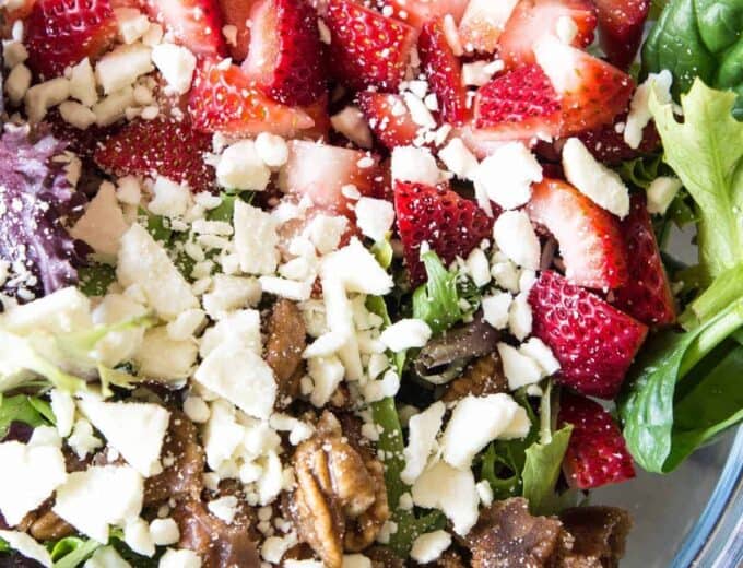 Strawberry Salad with Poppyseed Dressing. This salad is loaded up with fresh strawberries, candied pecans, feta cheese and drizzled with an easy to make sweet poppyseed dressing. Perfect dish for springtime!