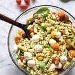 Pesto Pasta Salad! This pasta salad is loaded up with fresh mozzarella, juicy tomatoes, and coated with an easy to make homemade pesto sauce made with fresh basil and garlic.