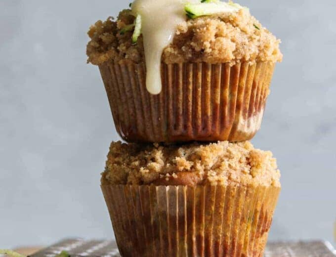 Zucchini Crumb Muffins with Lemon Cream Cheese Glaze.  These muffins are loaded up with fresh zucchini, spiced up with a hint of cinnamon, and made lighter by using greek yogurt!  Not to mention the sweet hint of crumb topping baked right into the muffin.  Top it all off with a drizzle of lemon cream cheese glaze. 