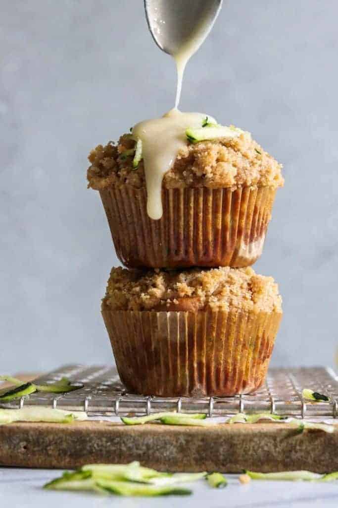 Zucchini Crumb Muffins with Lemon Cream Cheese Glaze.  These muffins are loaded up with fresh zucchini, spiced up with a hint of cinnamon, and made lighter by using greek yogurt!  Not to mention the sweet hint of crumb topping baked right into the muffin.  Top it all off with a drizzle of lemon cream cheese glaze. 