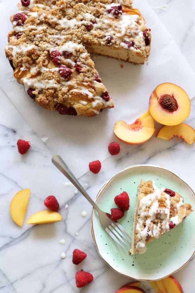 Peach Raspberry Crumb Cake!  A moist cake topped with fresh juicy peaches and sweet raspberries.  All covered in a sweet brown sugar crumb. 