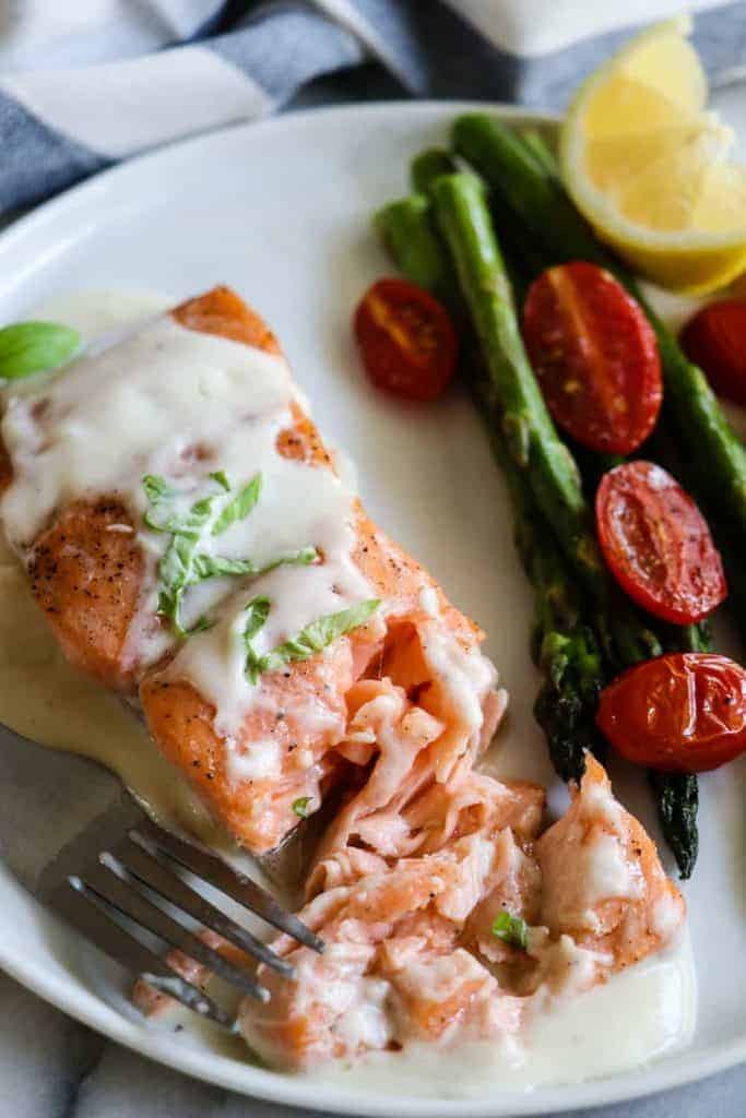 This easy to make Baked Salmon is topped with a flavorful, creamy Parmesan Cheese Sauce. Less than 30 minutes needed for this easy dinner recipe! 