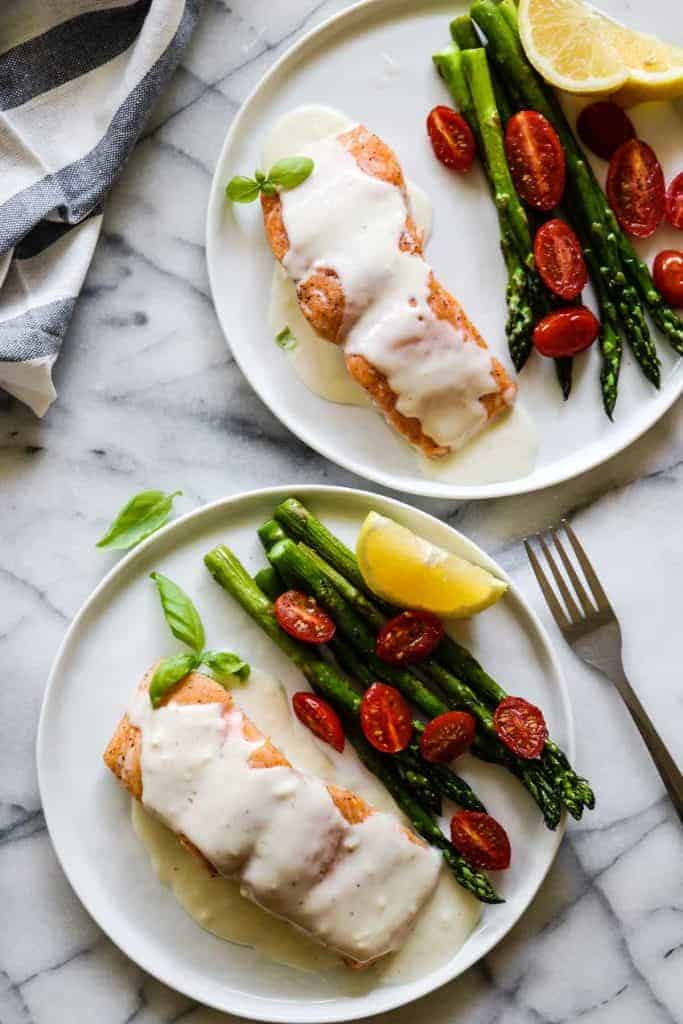 This easy to make Baked Salmon is topped with a flavorful, creamy Parmesan Cheese Sauce. Less than 30 minutes needed for this easy dinner recipe! 