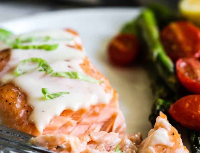 This easy to make Baked Salmon is topped with a flavorful, creamy Parmesan Cheese Sauce. Less than 30 minutes needed for this easy dinner recipe!