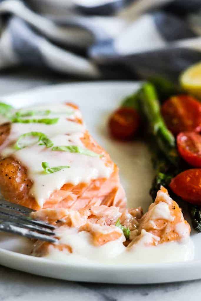 This easy to make Baked Salmon is topped with a flavorful, creamy Parmesan Cheese Sauce. Less than 30 minutes needed for this easy dinner recipe! 