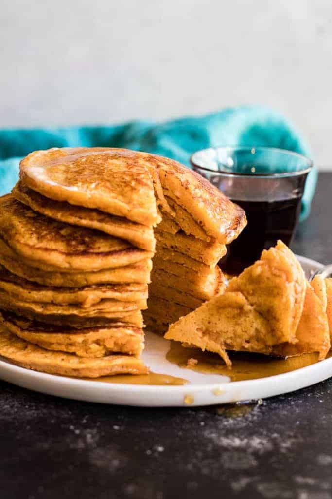 Soft and fluffy sweet potato pancakes made to the extreme with an overdose of spices and sweetened with maple syrup. Fall breakfast perfection.