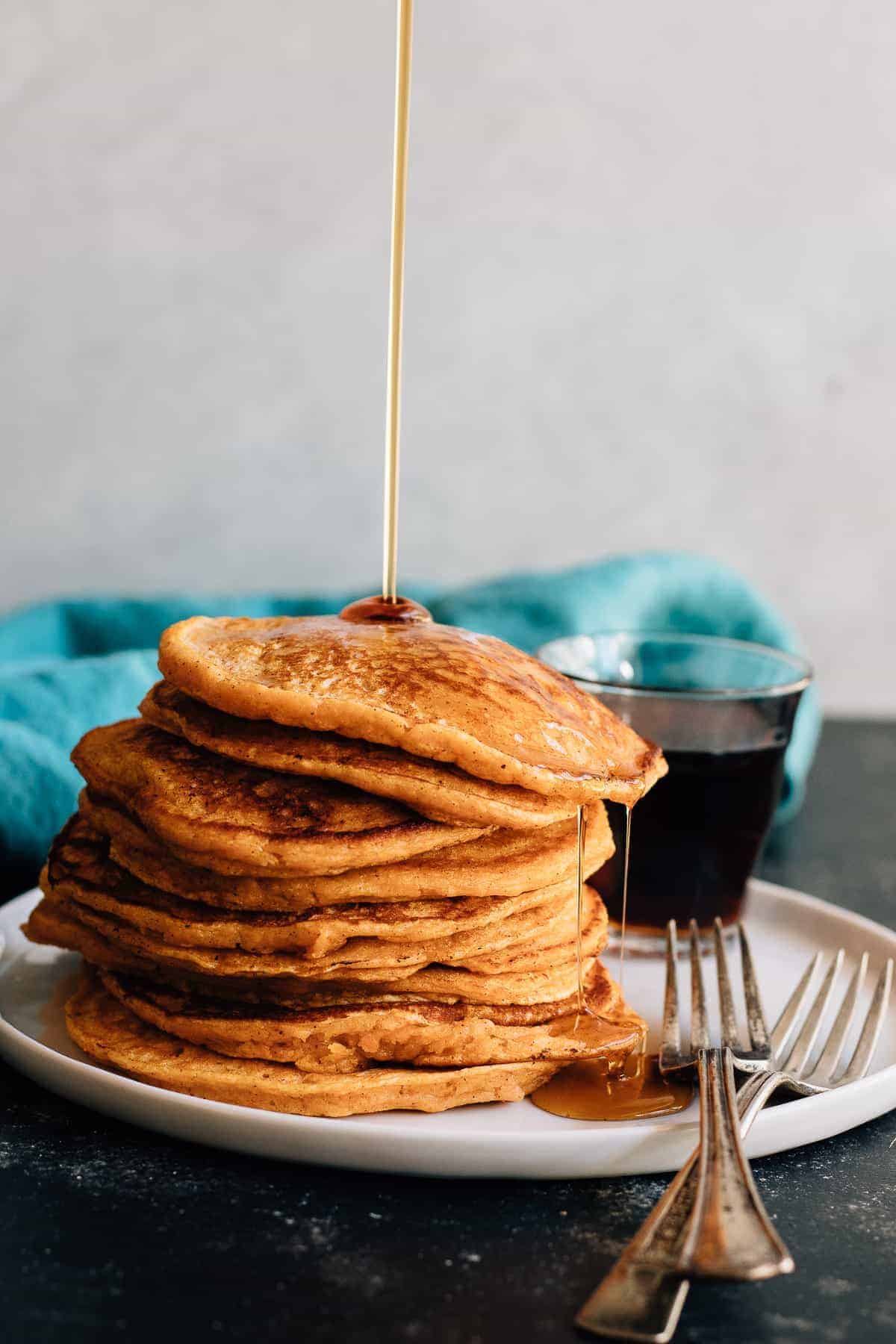 Soft and fluffy sweet potato pancakes made to the extreme with an overdose of spices and sweetened with maple syrup. Fall breakfast perfection.