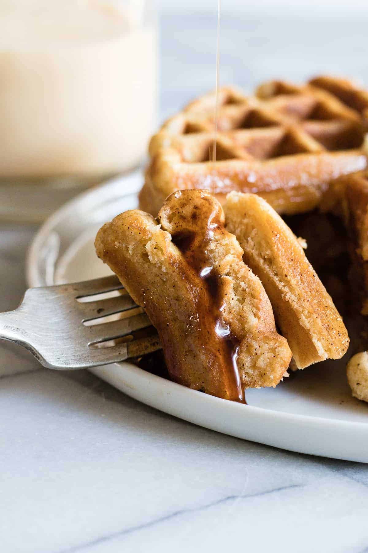 Light and fluffy waffles made with eggnog and drizzled with a homemade cinnamon syrup. 