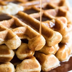 Light and fluffy waffles made with eggnog and drizzled with a homemade cinnamon syrup. 