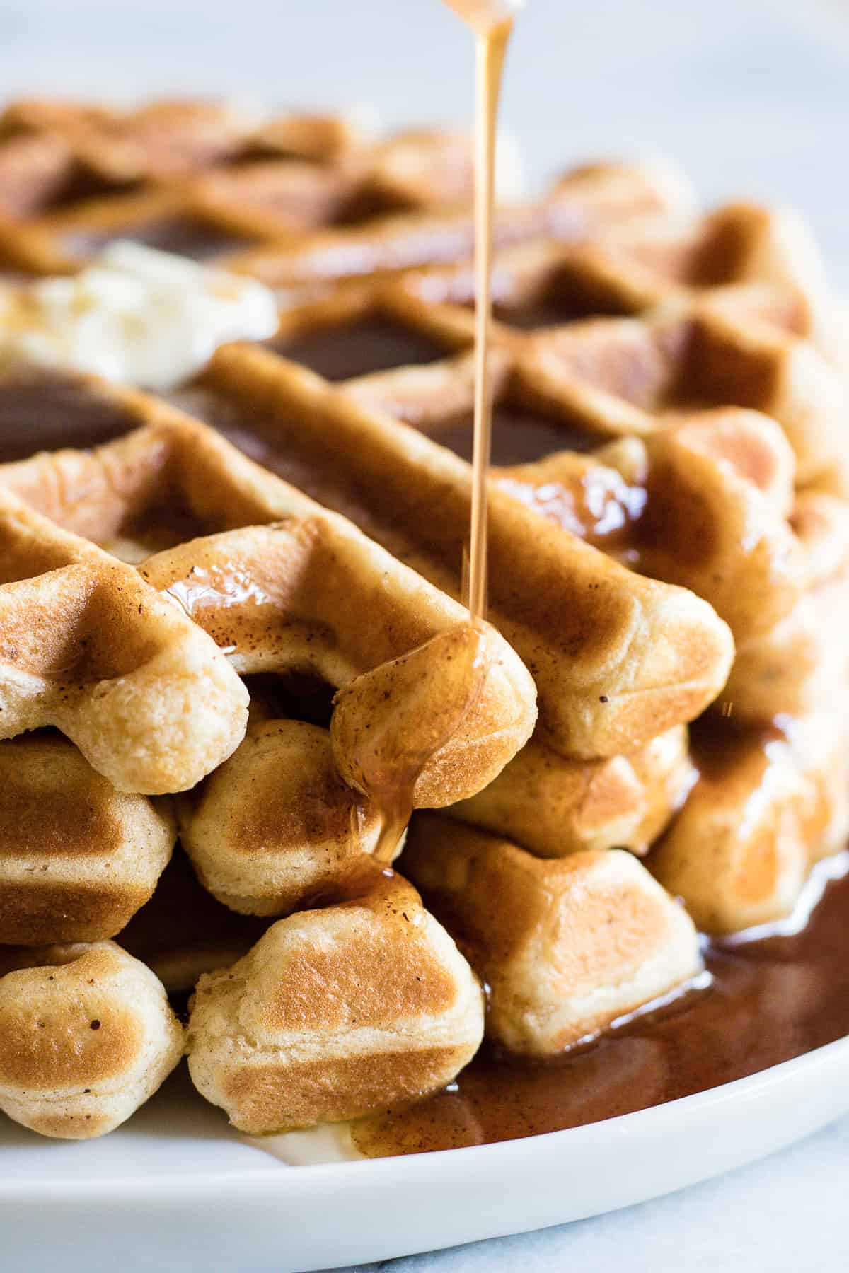 Light and fluffy waffles made with eggnog and drizzled with a homemade cinnamon syrup. 