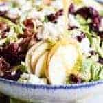 Finely chopped brussels sprouts make the best salad! Loaded up with bacon, feta, cranberries, and apples. All drizzled with a homemade bacon vinaigrette.