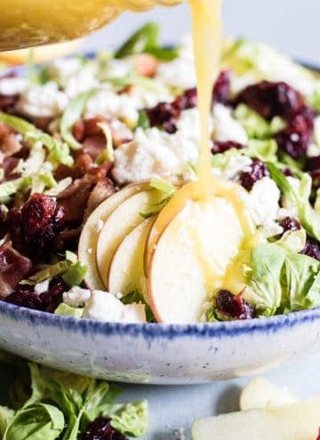 Finely chopped brussels sprouts make the best salad! Loaded up with bacon, feta, cranberries, and apples. All drizzled with a homemade bacon vinaigrette.
