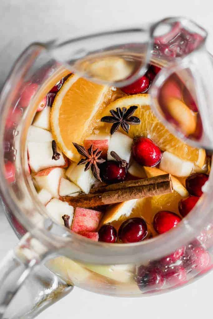 Sparkling Apple Cider Sangria. Sparkling Apple cider loaded up with chunks of apple, orange, cranberries, and all the best fall spices. No alcohol included makes this perfect for the entire family! 