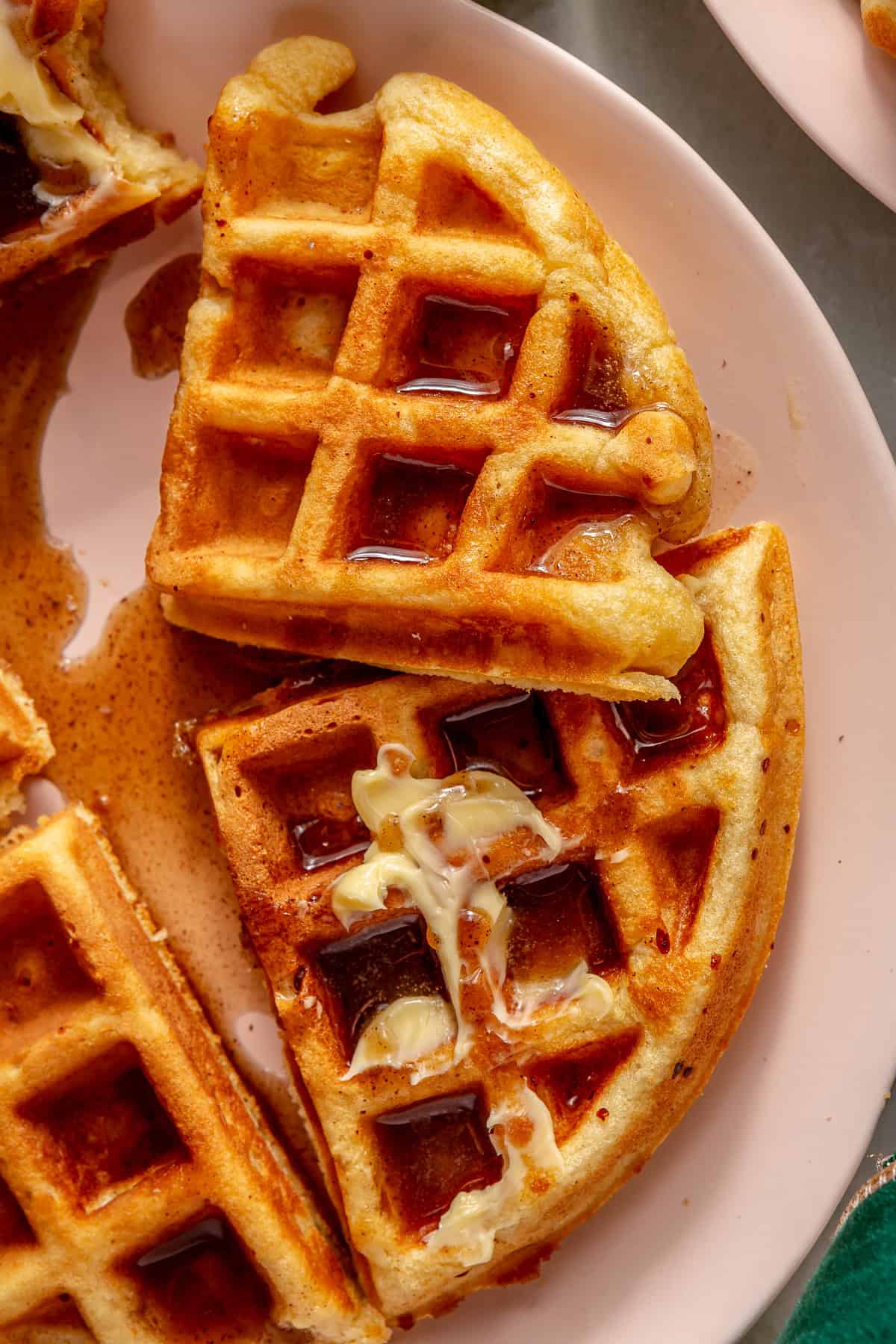 Eggnog waffles smeared with butter and drizzled with cinnamon syrup. 