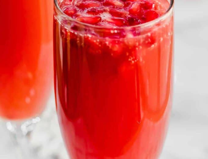 Christmas Mimosas! Celebrate Christmas in the morning with this mimosa that has a combination of orange juice and pomegranate juice! 