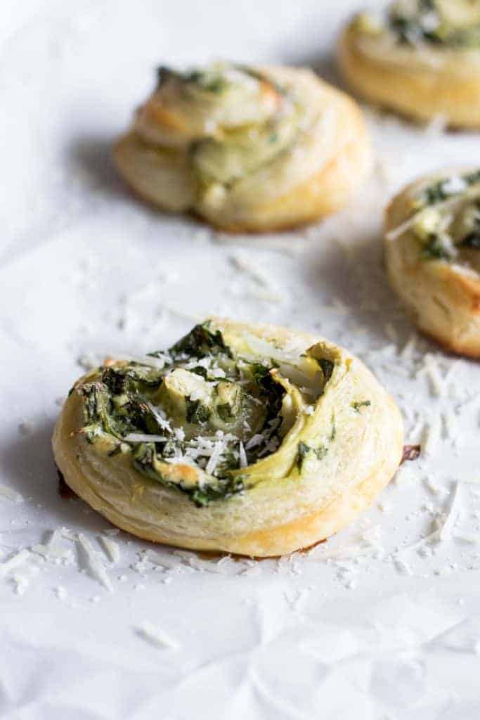 Puff Pastry Spinach and Artichoke Pinwheels. This easy to put together appetizer is perfect for any party or just as a snack. Loaded with fresh spinach, artichoke, and lots of cheese! 