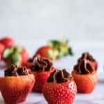 Chocolate Mousse filled strawberries and uncut strawberries in the background.