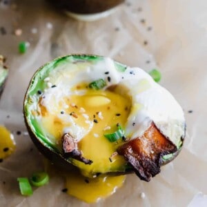 Avocado baked eggs with runny yolk.