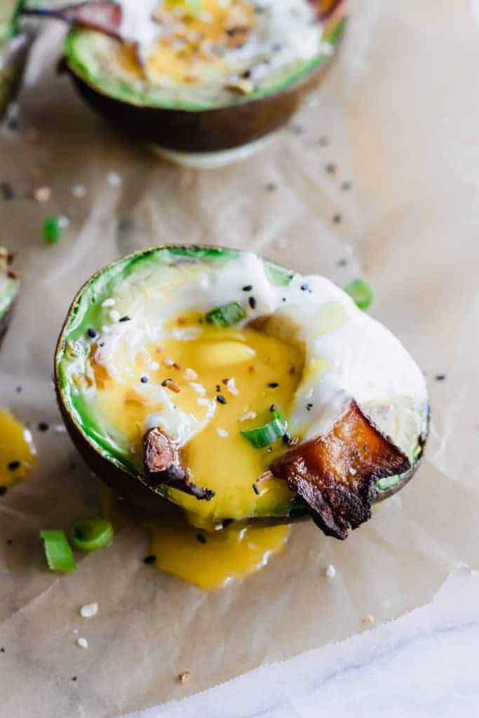 Avocado baked eggs with runny yolk.