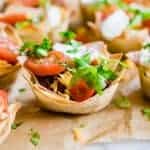 Taco cups. Crunchy wonton cups filled with uicy taco meat, melty cheese, shredded lettuce, tomato and sprinkled cilantro.