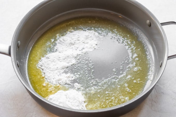 Melted butter in a large saucepan with flour sprinkled in.