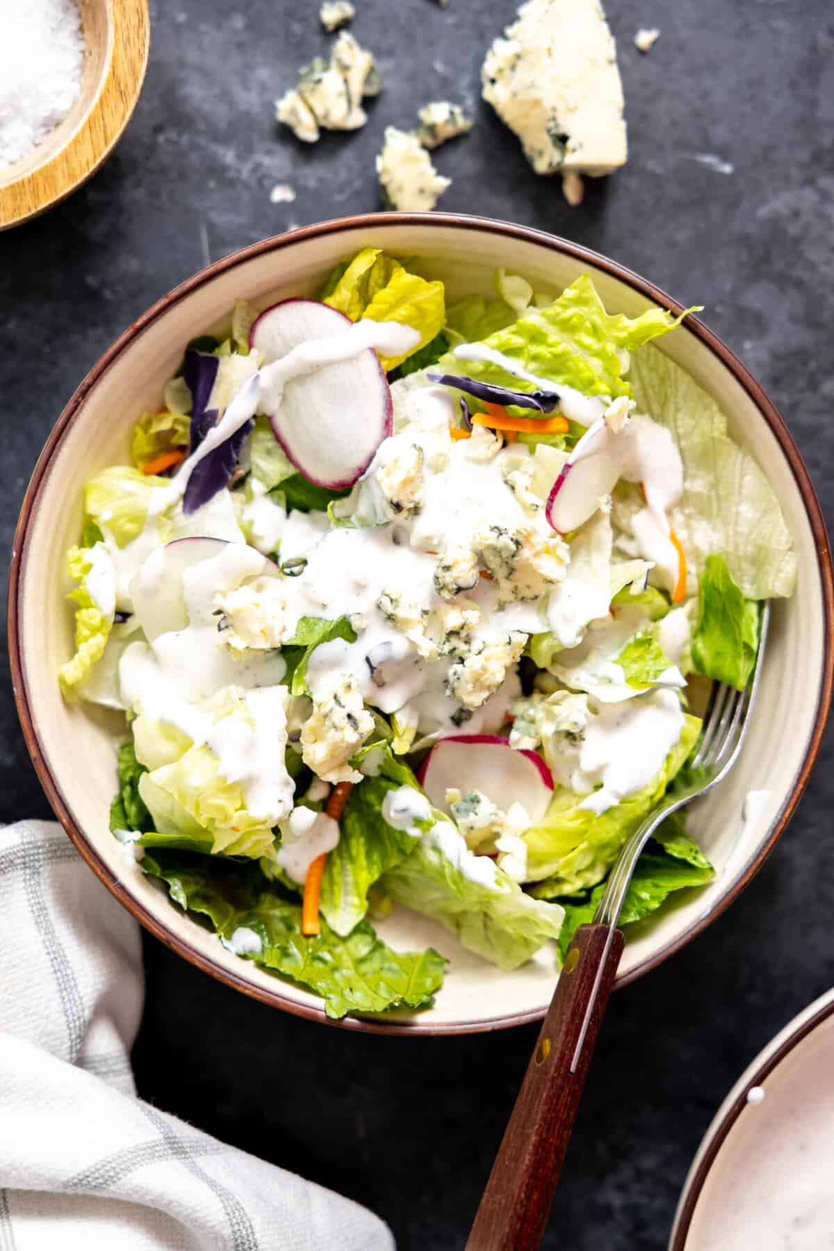 House salad topped with blue cheese dressing.