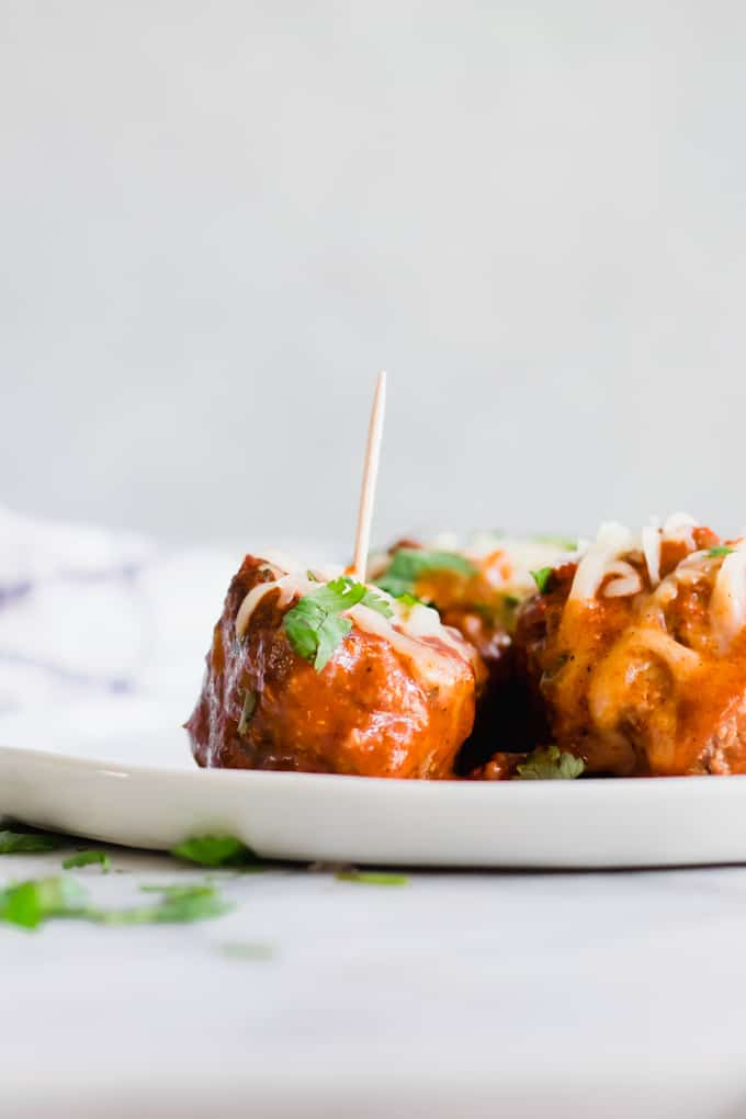 Tex Mex Chorizo Enchilada Meatballs on a plate with toothpicks.