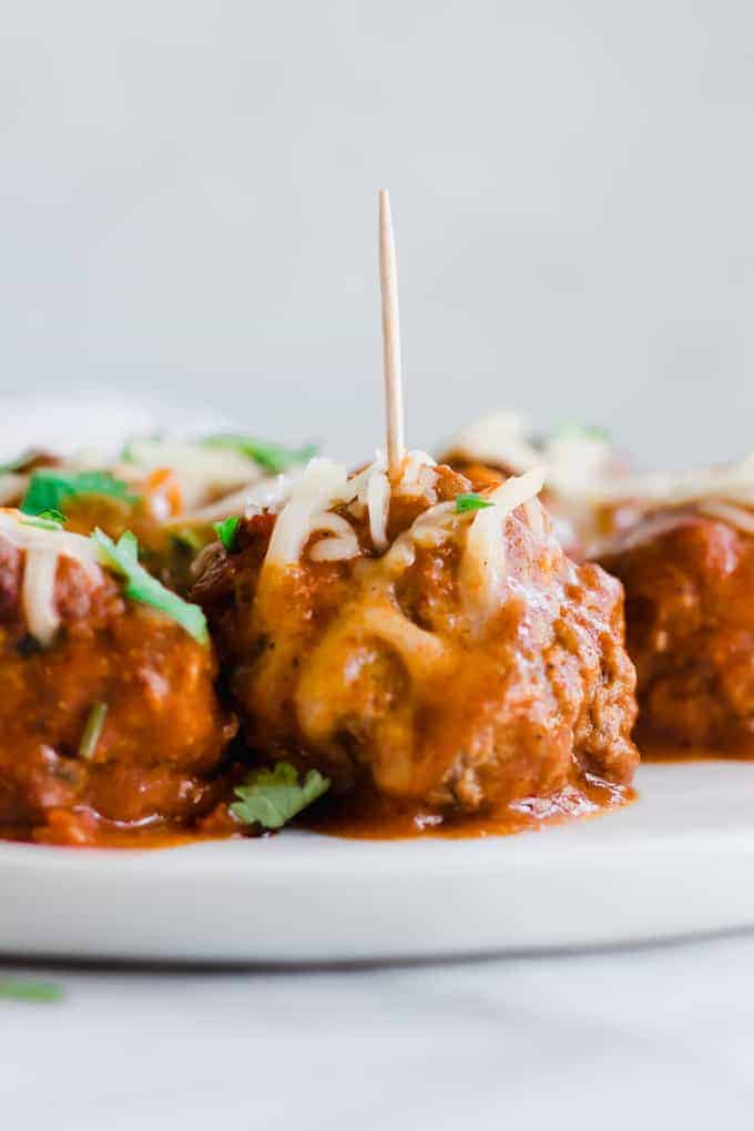 Tex Mex Chorizo Enchilada Meatballs on a plate with toothpicks.