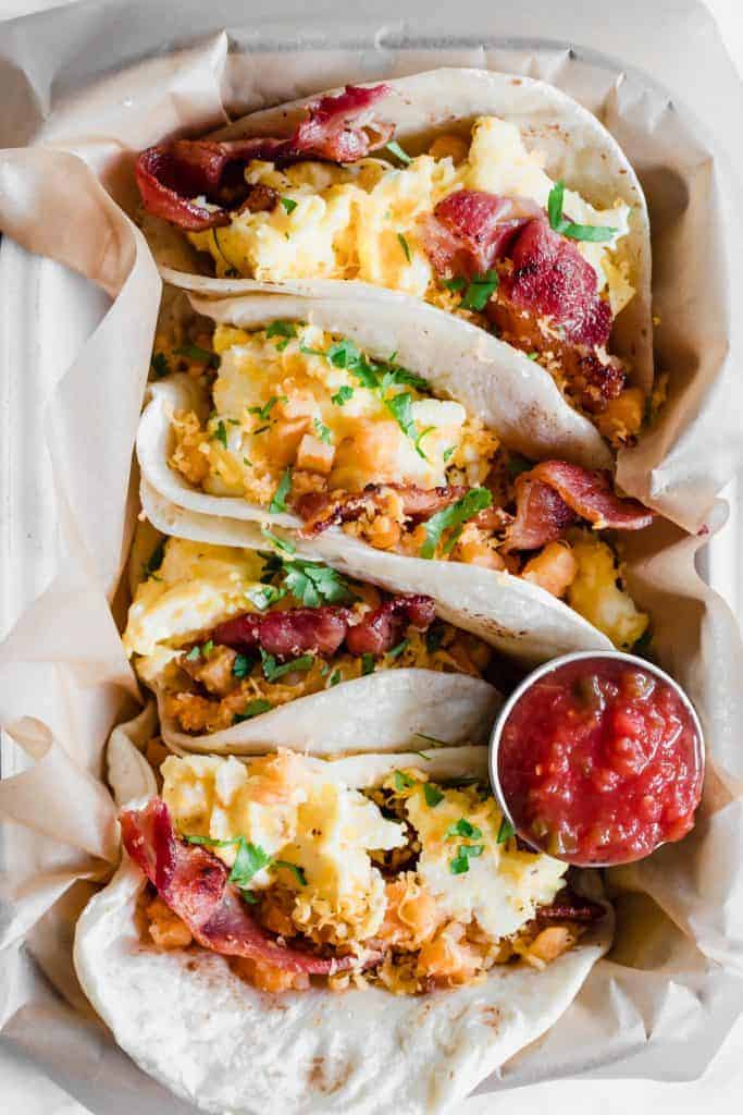 Texas Style Breakfast Tacos. Breakfast tacos loaded up with breakfast potatoes, scrambled egg, bacon and topped with cilantro.