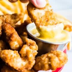 Copycat chick fil a nugget dipping into chick fil a sauce.