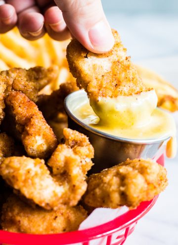 Copycat chick fil a nugget dipping into chick fil a sauce.