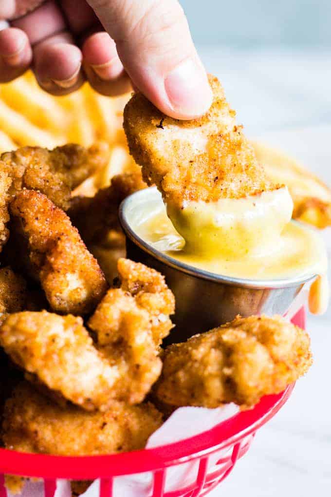 Copycat chick fil a nugget dipping into chick fil a sauce.