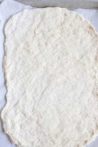 No yeast pizza dough rolled out waiting for toppings.