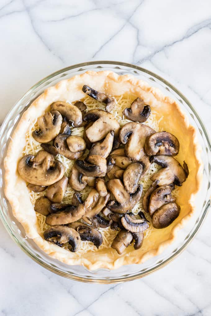 Pie crust with cooked mushrooms. 