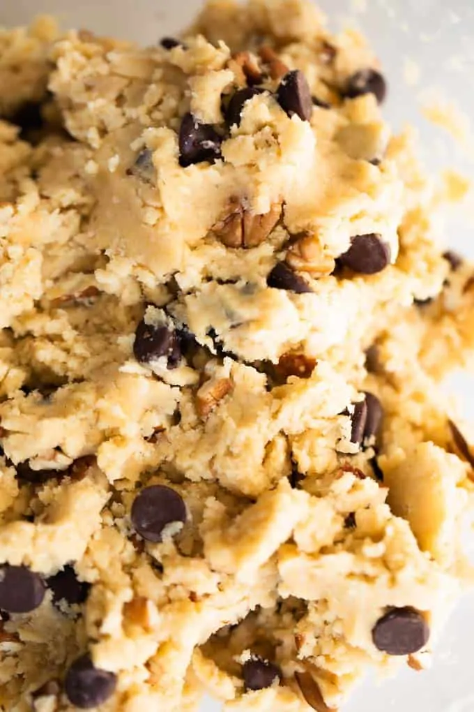 Chocolate chip cookie dough in a glass bowl.