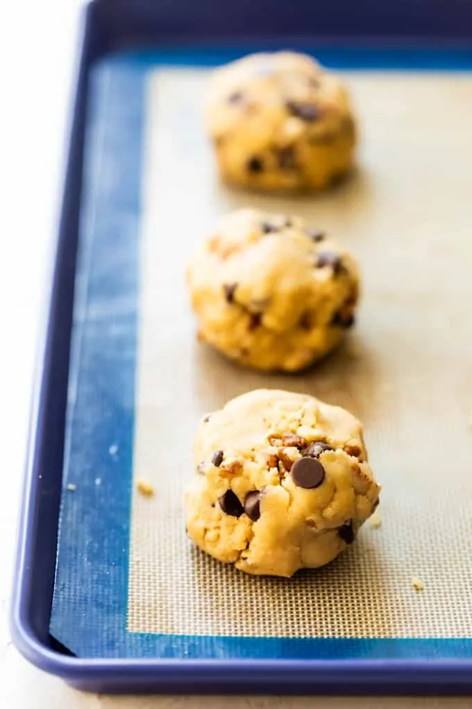 Balls of cookie dough on a baking sheet.