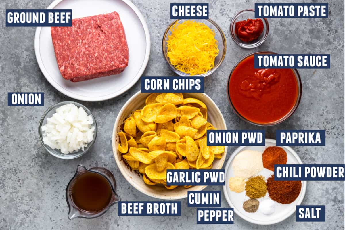 Ingredients needed to make Frito pie laid out on the counter. 