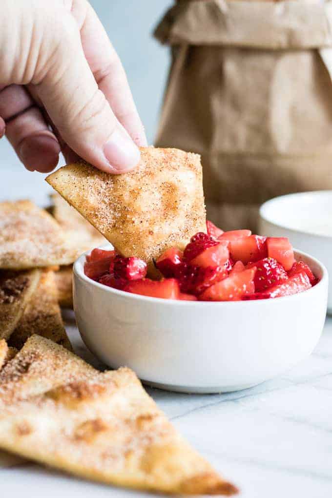 Cinnamon Tortilla Chips dipping into strawberry salsa.