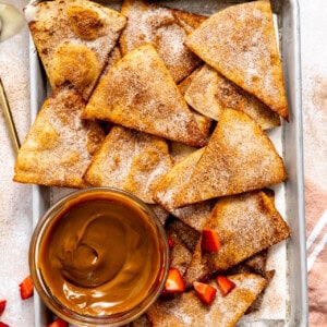 Baking tray with Cinnamon Tortilla Chips served with dulce de leche and fudge sauce.