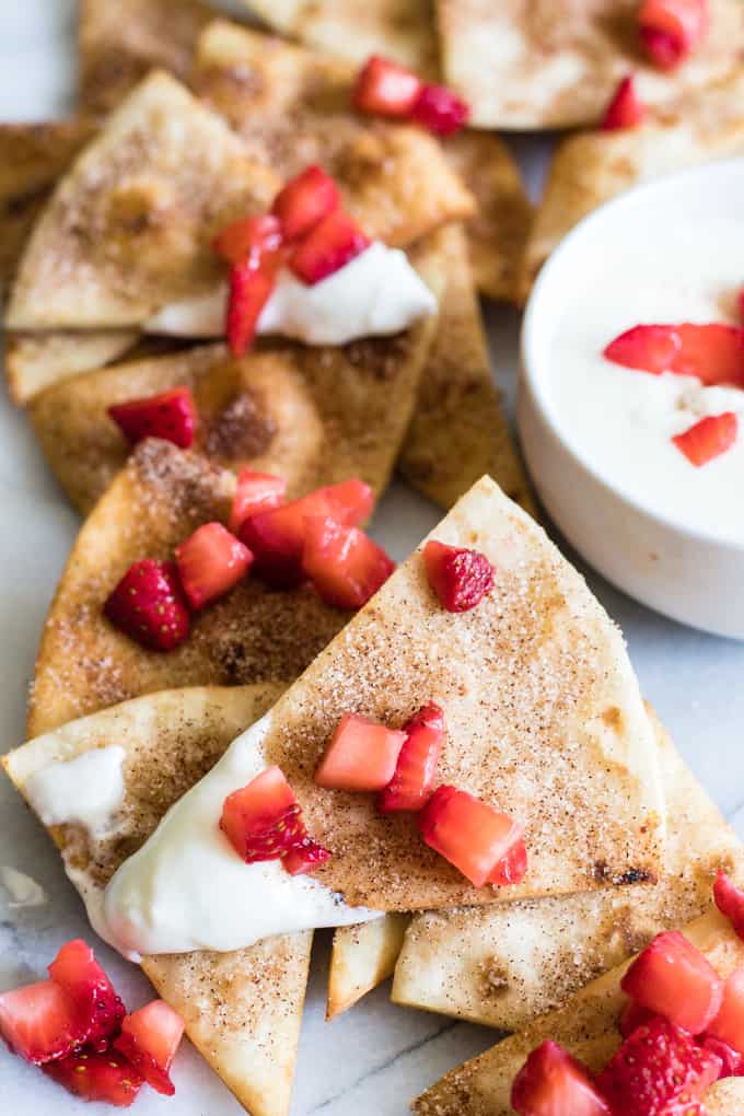 Cinnamon Tortilla Chips dipped into a cream cheese glaze and topped with diced strawberries.