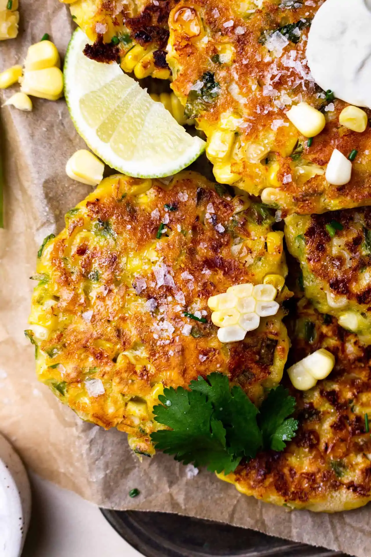 Fresh homemade corn fritters laid out to cool after frying.